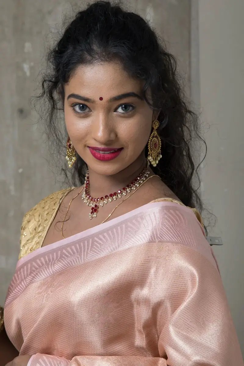 Smiling model in a pink saree