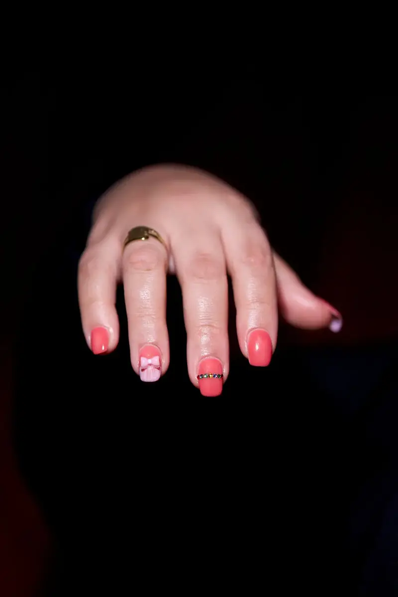 Hand with coral nail art
